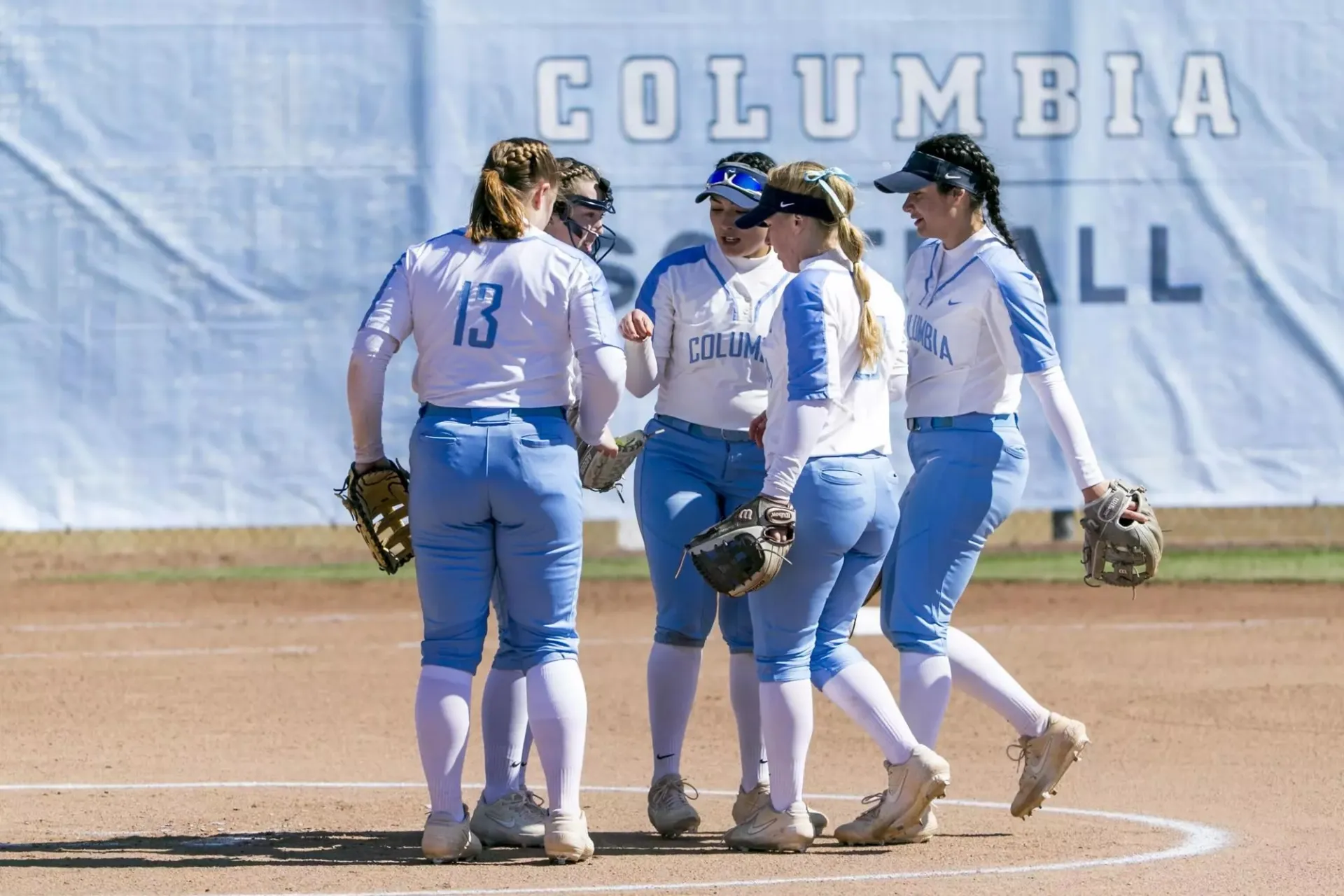 Image of softball huddle at base